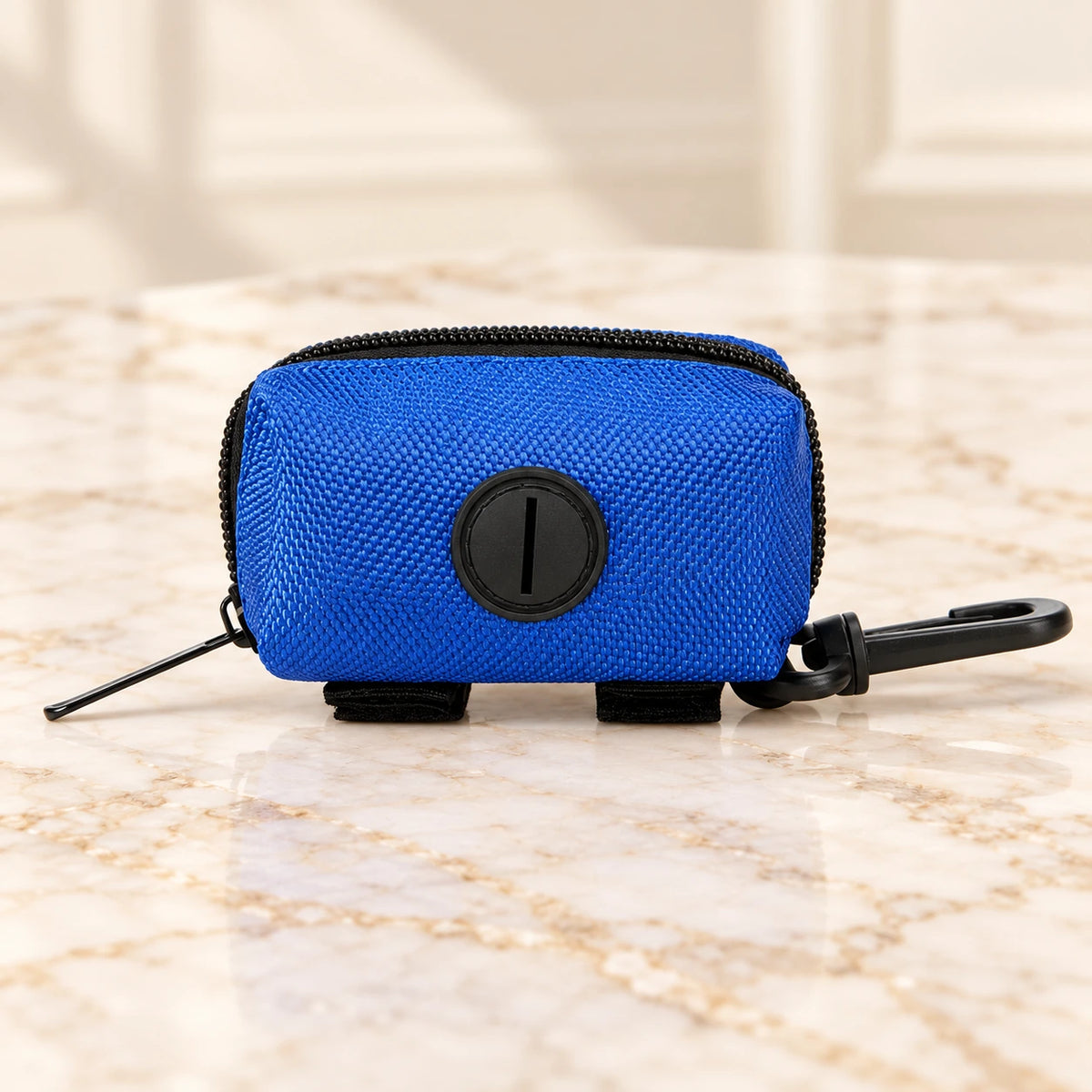 Dark-blue unlabelled waste-bag pouch with black clip and dispensing port