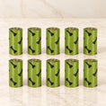 Charger l'image dans la visionneuse de la galerie, Ten olive-green black-bone-print waste-bag refill rolls arranged in two rows of five
