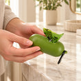 Charger l'image dans la visionneuse de la galerie, Hands holding the olive waste-bag dispenser above an ivory marble console
