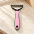 Cargar la imagen en la vista de la galería, Pink and grey double-sided grooming comb, large head, on beige marble
