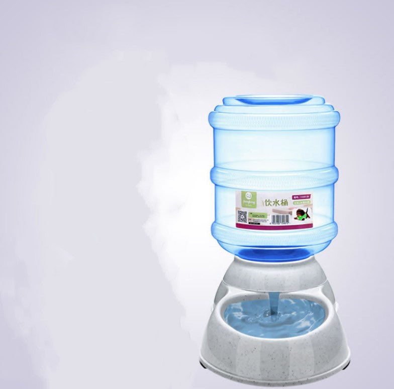 Automatic pet water dispenser with transparent blue water container and white-speckled base shown in isolation