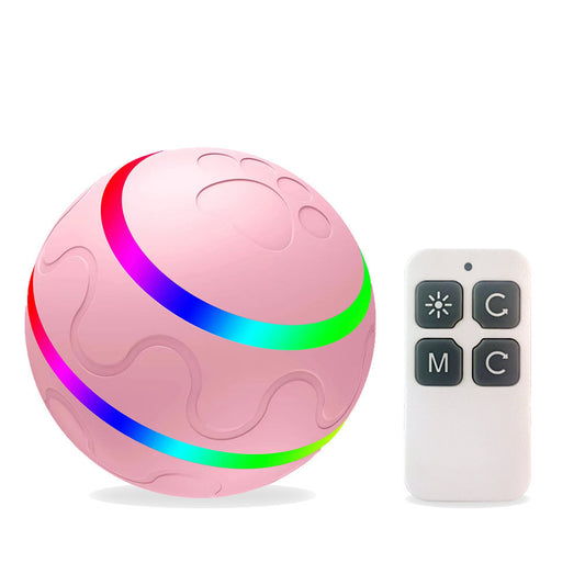 Pink intelligent cat ball with paw print design next to a white remote control with four buttons