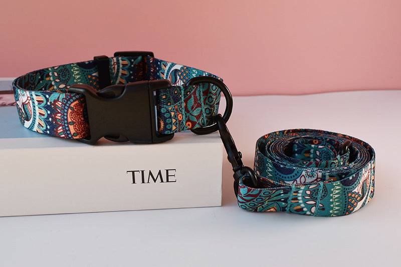 Close-up of dark green ethnic print nylon dog collar and leash set with black plastic buckle on white box