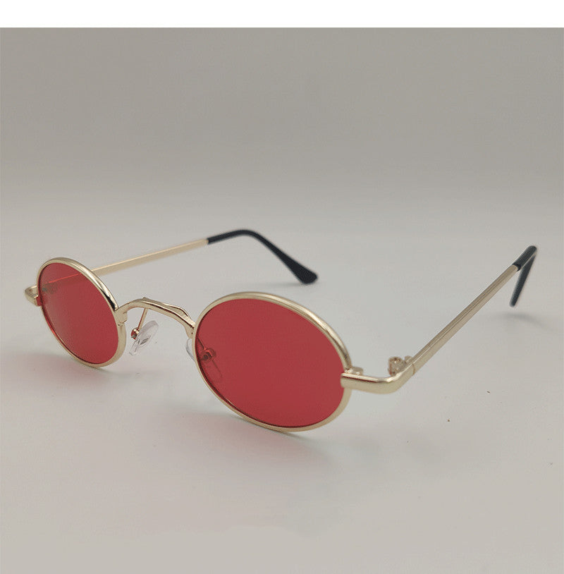 Red oval dog sunglasses toy on white background with black ear tips