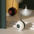 Load image into Gallery viewer, Two automatic rolling cat toys in white-green and red-black colors displayed near a step
