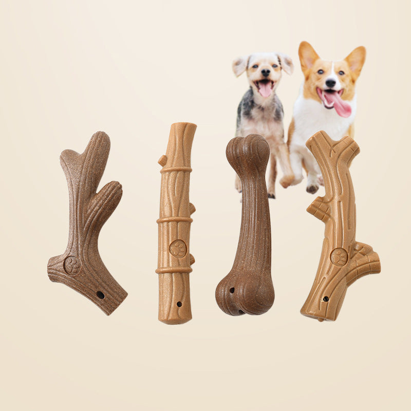 Four dog chew toys shaped like sticks and bones with two small happy dogs in background