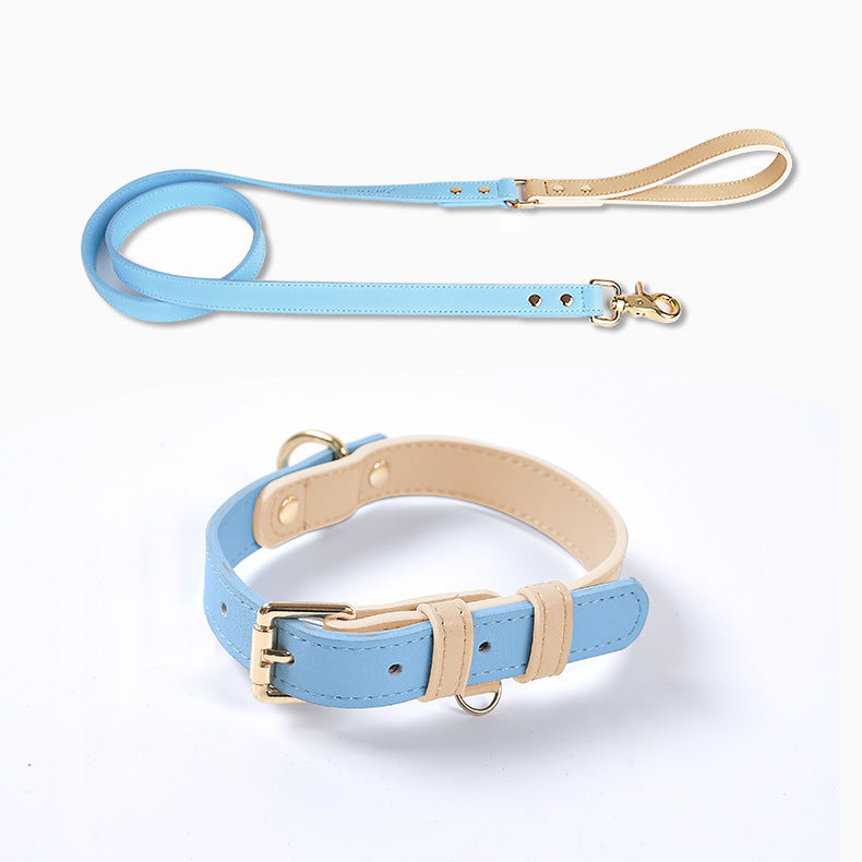 Light blue leather dog leash with beige handle and matching collar on white background