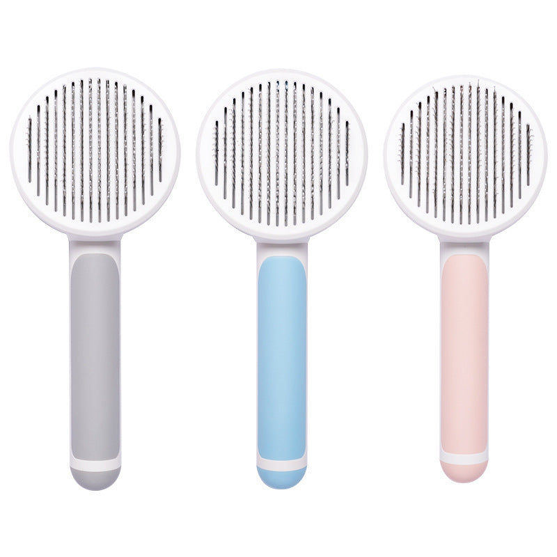 Set of three pet hair combs with round heads in gray, blue, and pink colors
