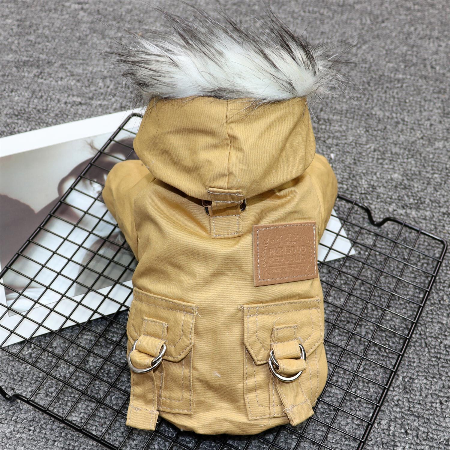 Back view of a khaki winter dog coat with faux fur-trimmed hood and leather patch logo