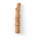 Load image into Gallery viewer, Light brown textured stick-shaped dog chew toy with small nubs on white background
