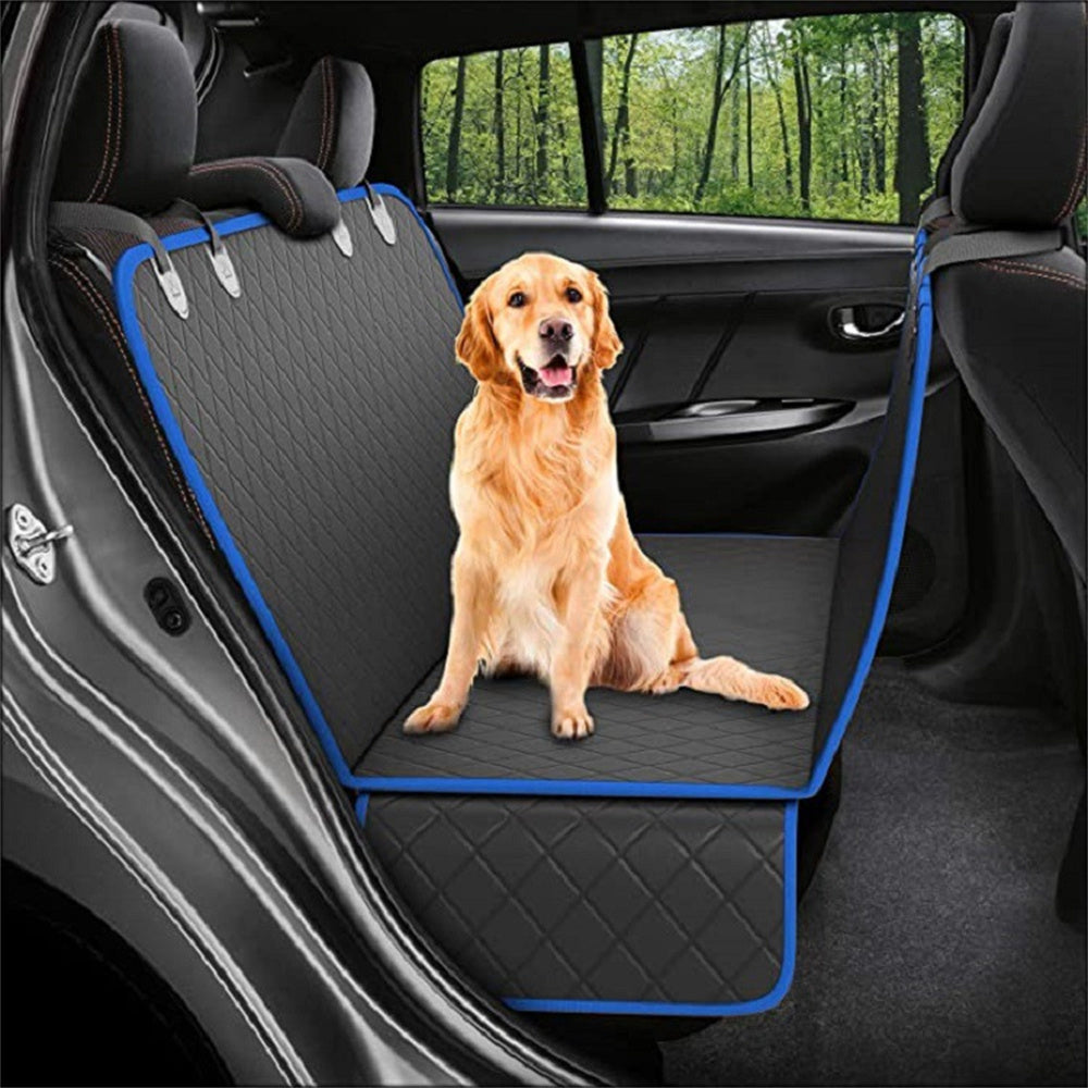 Golden retriever sitting on black quilted waterproof car seat cover with blue trim installed in rear car seat