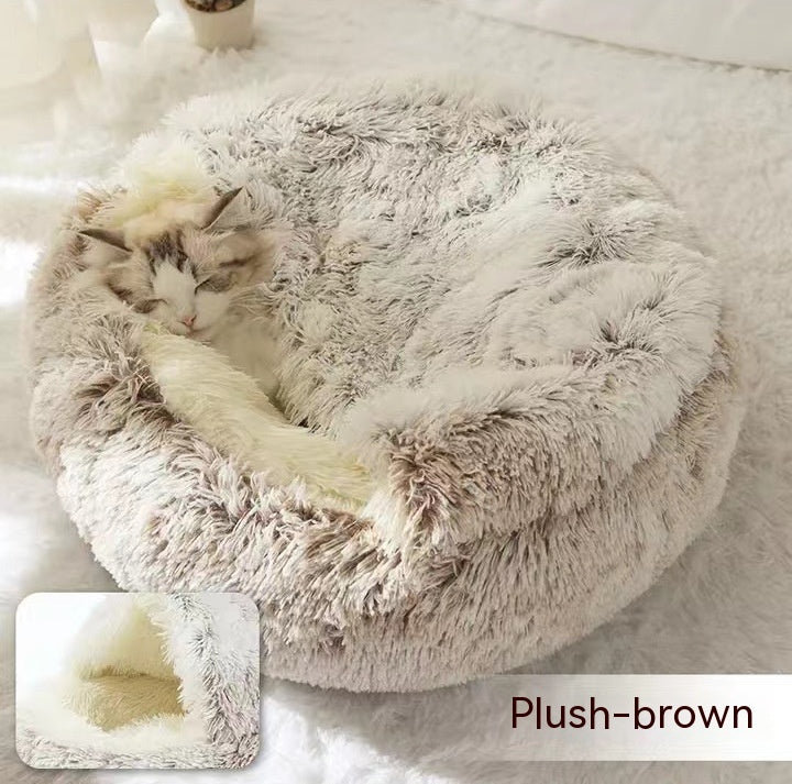 Cat sleeping inside brown plush fur dome pet bed
