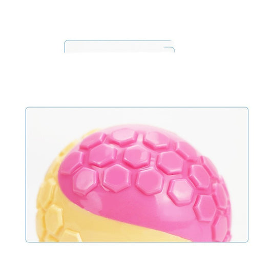 Close-up of pink and beige rubber chew ball with hexagonal pattern