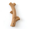 Load image into Gallery viewer, Light brown stick-shaped dog chew toy with branch-like texture and paw print emblem
