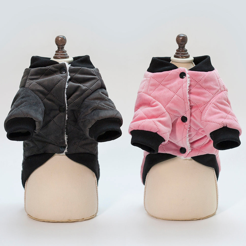 Charcoal gray and pink dog jackets open to show plush interior lining and button closures on mannequins