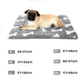 Load image into Gallery viewer, Pug lying on gray and white bone patterned plush pet bed mat, size chart shown
