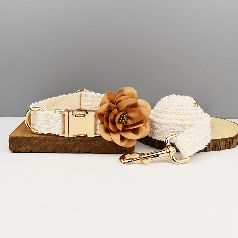 Dog collar and leash set displayed on wood slice with flower decoration