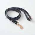 Load image into Gallery viewer, Close-up of black PU leather dog leash with metal clasp and colored stitching details
