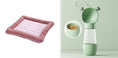 Load image into Gallery viewer, Pink cooling pet bed mat with gray striped cushions beside green pet feeder with heart handles and food bowl.
