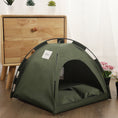 Cargar la imagen en la vista de la galería, Side view of olive green indoor pet tent bed with cushioned interior beside wooden drawer and flowers
