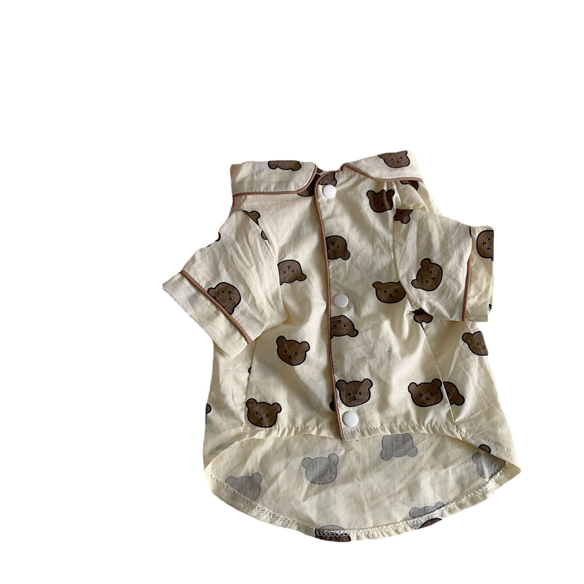 Flat lay of beige brown bear printed cotton pet pajama shirt with snap buttons and brown piping