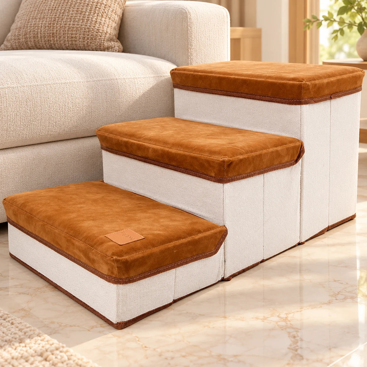Brown foldable three-step pet stairs beside a cream sofa