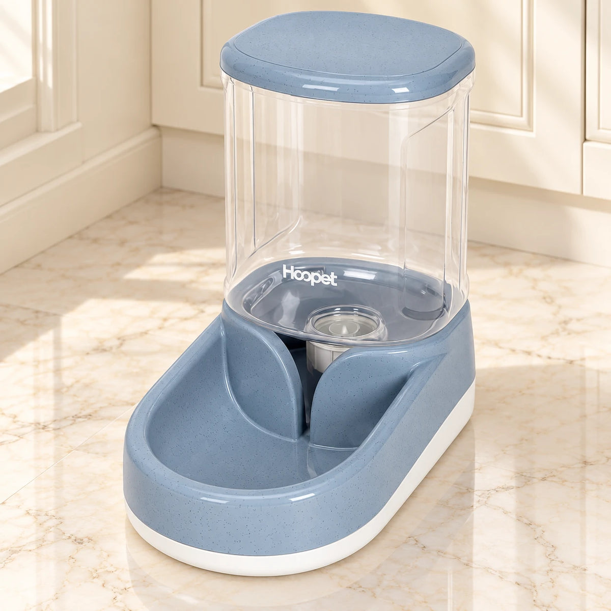 Grey gravity pet water dispenser with clear reservoir and white base on pale marble