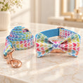 Charger l'image dans la visionneuse de la galerie, Multicolour heart-print dog collar with bow and matching leash with rose-gold hardware on an ivory marble console

