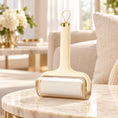 Load image into Gallery viewer, Pale-yellow lint roller on a marble side table beside a cream linen sofa

