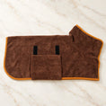 Load image into Gallery viewer, Coffee brown dog drying robe with orange trim and belly flap on ivory marble
