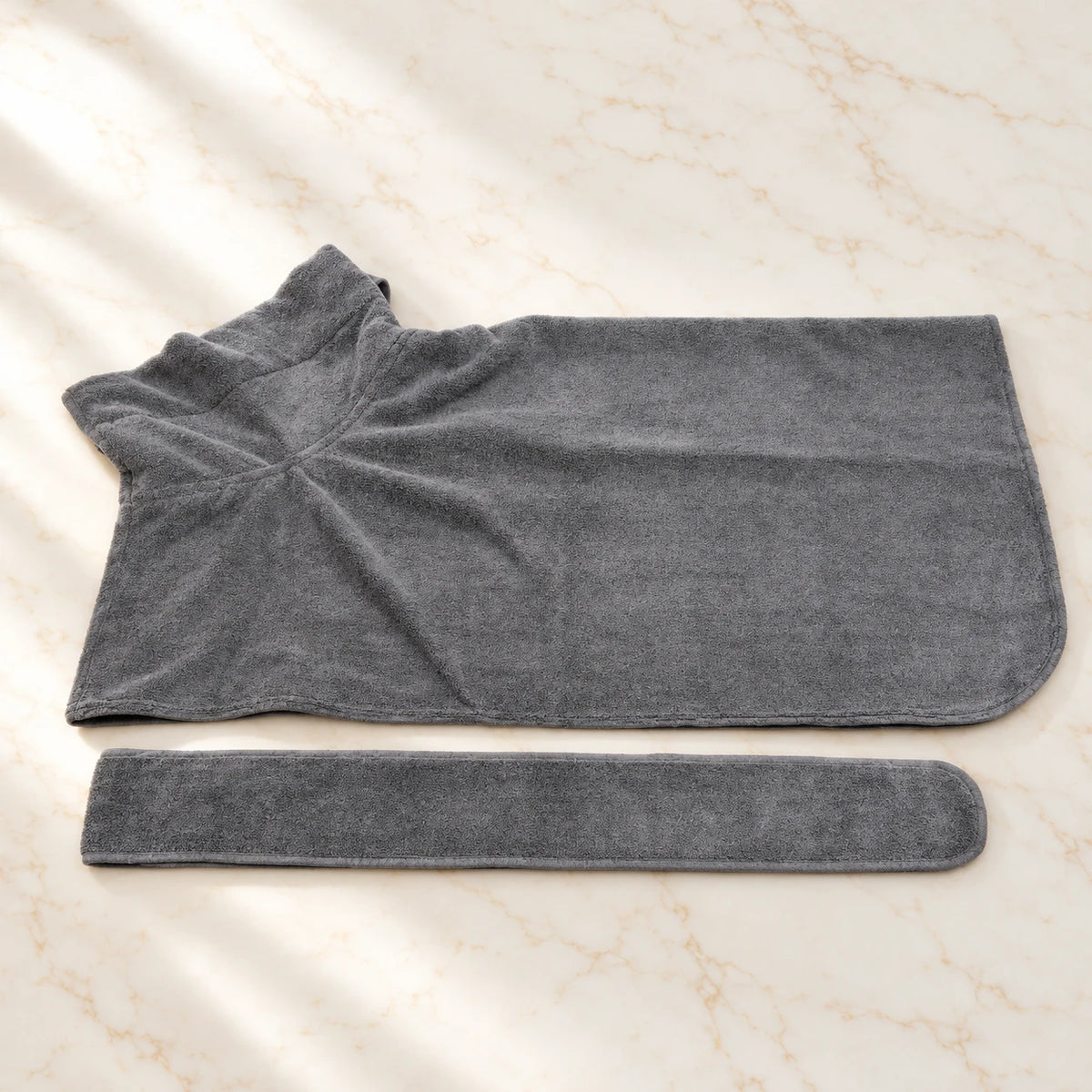Plain grey dog drying robe with separate matching belt on ivory marble