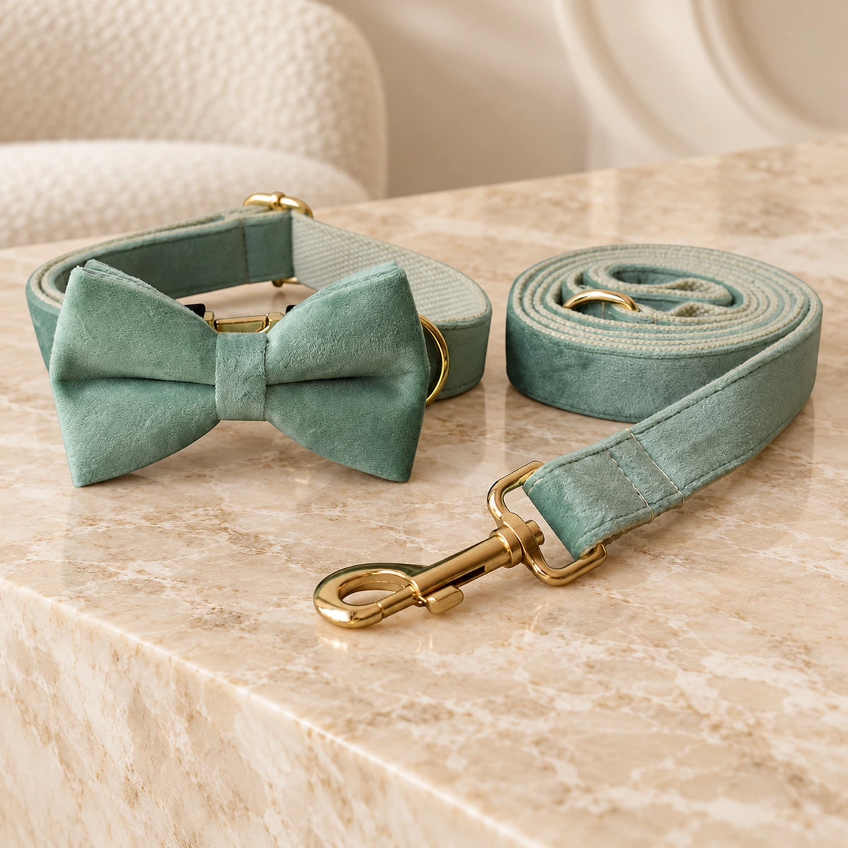 Mint velvet bow collar and matching leash with gold-tone fittings on beige marble