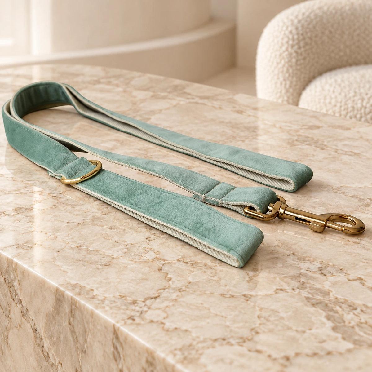 Mint velvet dog leash with gold-tone clip on beige marble
