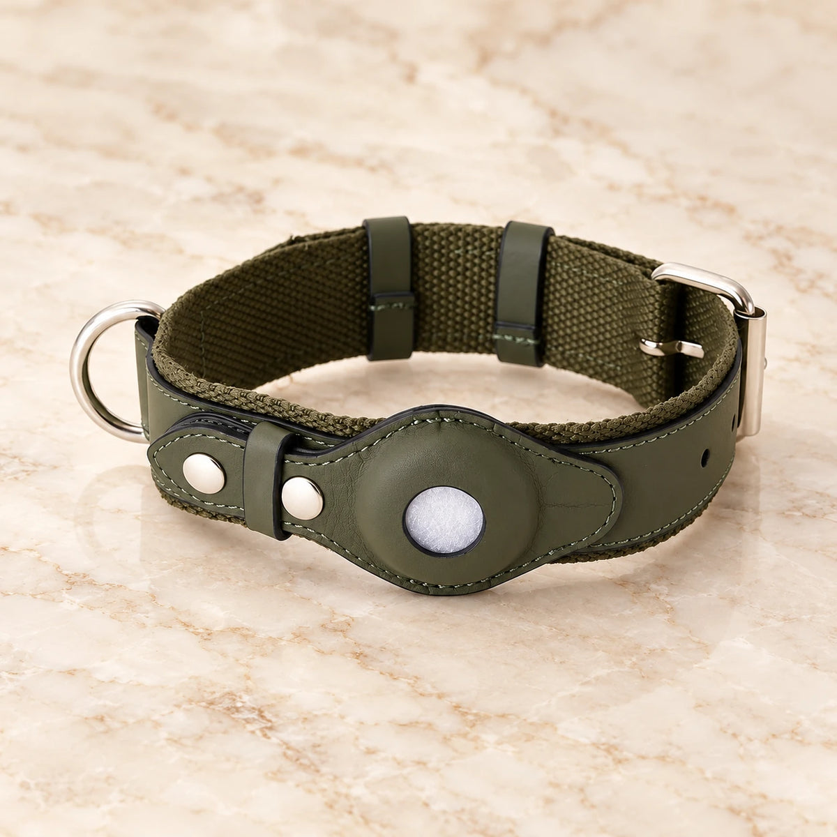 Olive dog collar with round tracker holder and silver-tone hardware on ivory marble