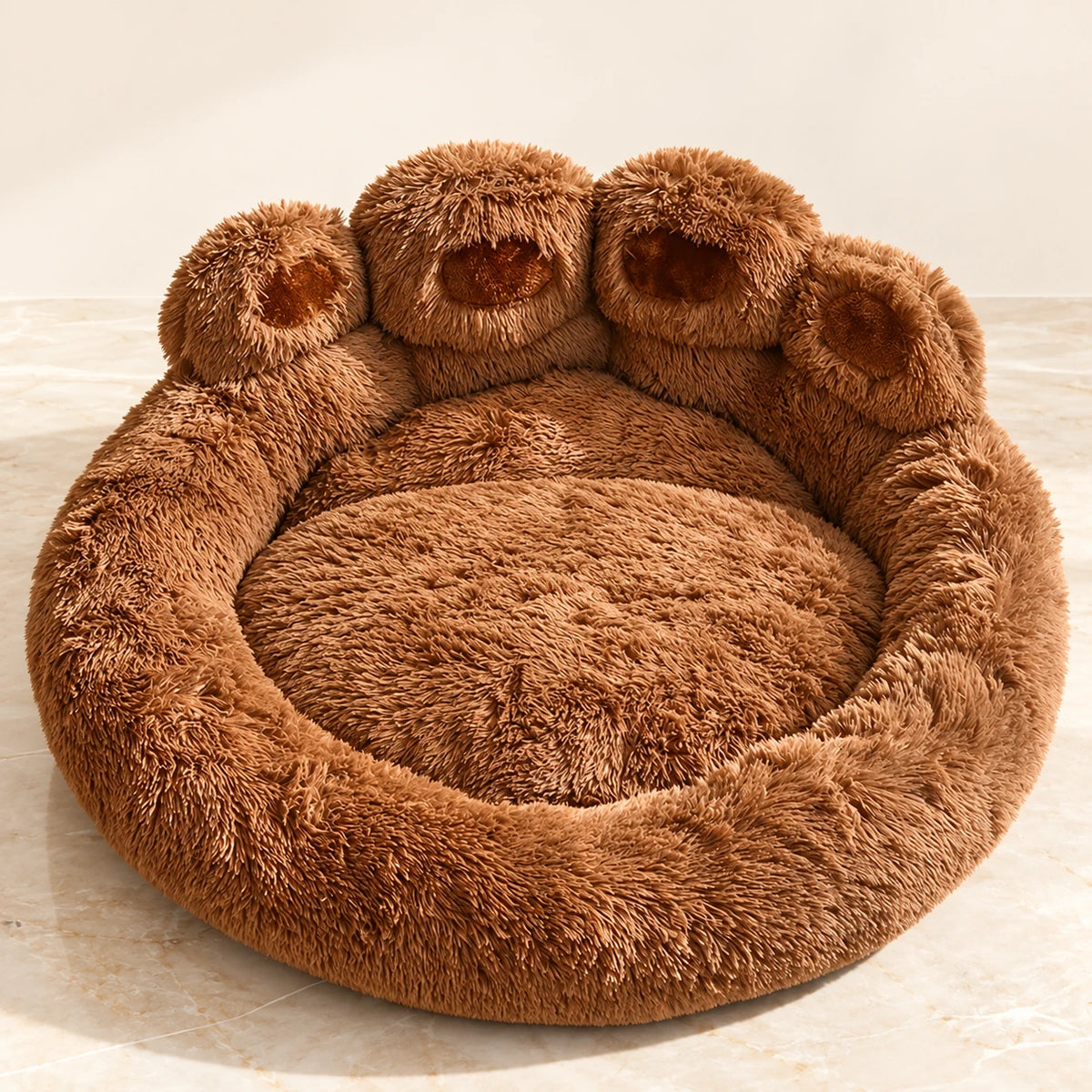 Coffee-brown plush paw-shaped pet bed with four toe cushions on ivory marble