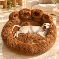 Charger l'image dans la visionneuse de la galerie, Cream Labrador puppy resting in a coffee-brown paw-shaped bed in a beige lounge
