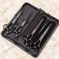 Load image into Gallery viewer, Black pet grooming set with four scissors, comb and forceps in an open black zip case
