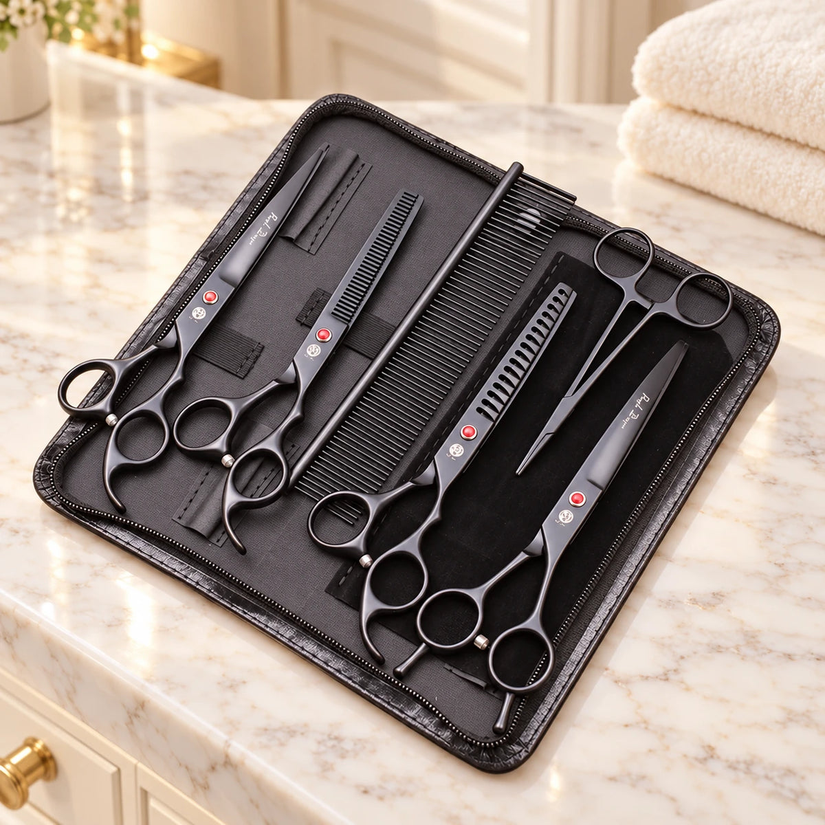Black grooming scissor set in its open case on a cream marble vanity