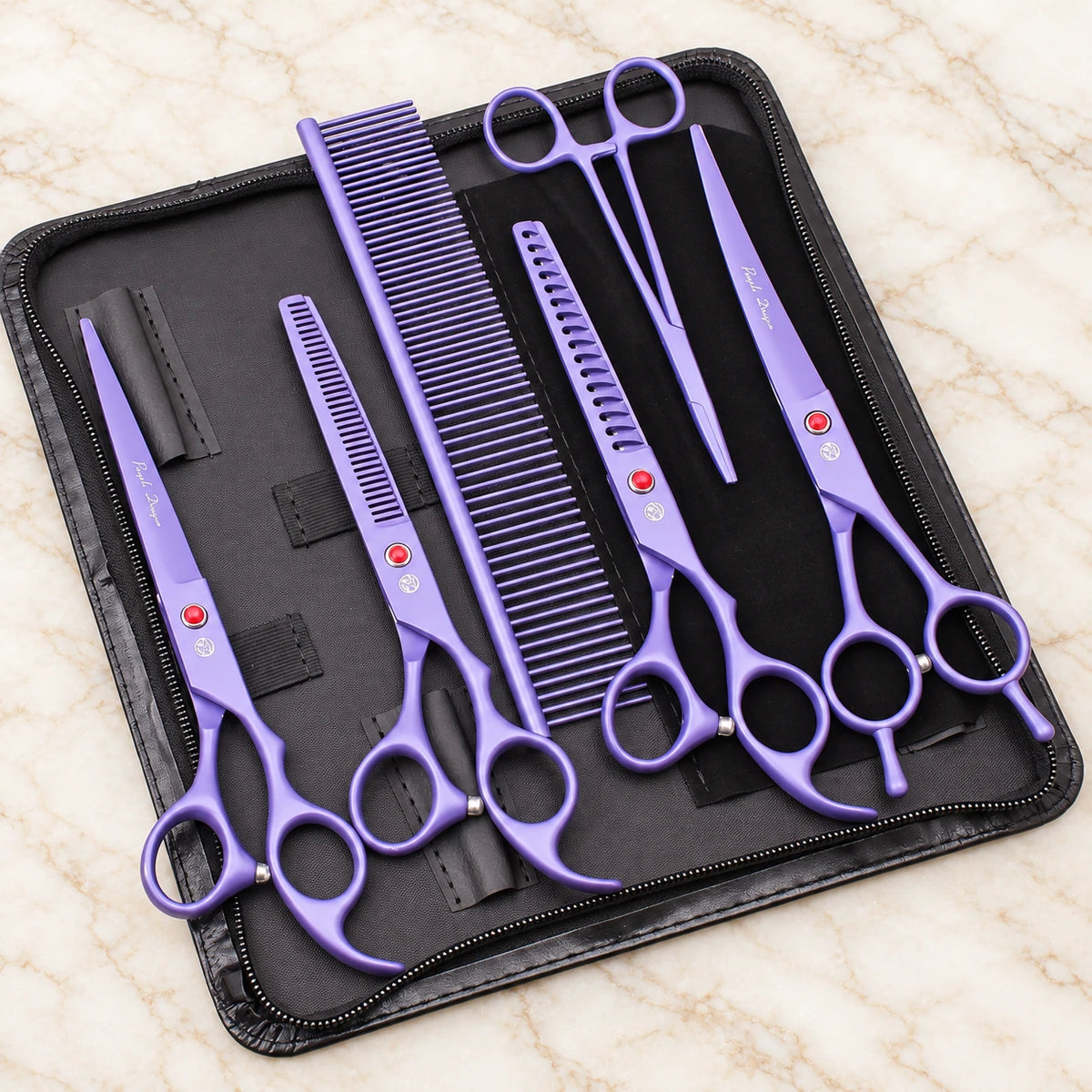 Purple pet grooming set with four scissors, comb and forceps in an open black zip case