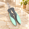 Load image into Gallery viewer, Green ergonomic pet nail clippers on pale ivory marble
