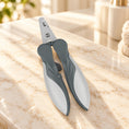 Load image into Gallery viewer, Grey ergonomic pet nail clippers on pale ivory marble
