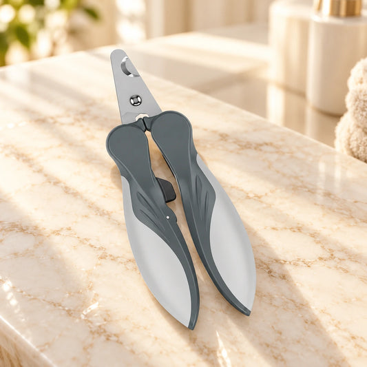 Grey ergonomic pet nail clippers on pale ivory marble