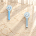 Charger l'image dans la visionneuse de la galerie, Blue and grey round-head grooming brushes showing rear buttons on beige marble
