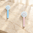 Charger l'image dans la visionneuse de la galerie, Blue and pink round-head grooming brushes showing rear buttons on beige marble
