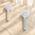 Charger l'image dans la visionneuse de la galerie, Pink and grey round-head grooming brushes showing rear buttons on beige marble
