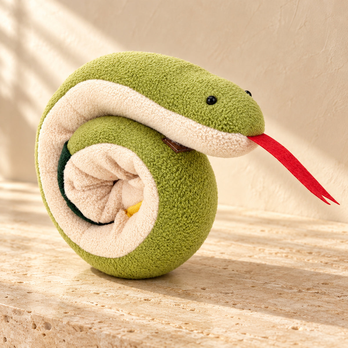 Coiled green and cream fleece snake snuffle toy with red tongue
