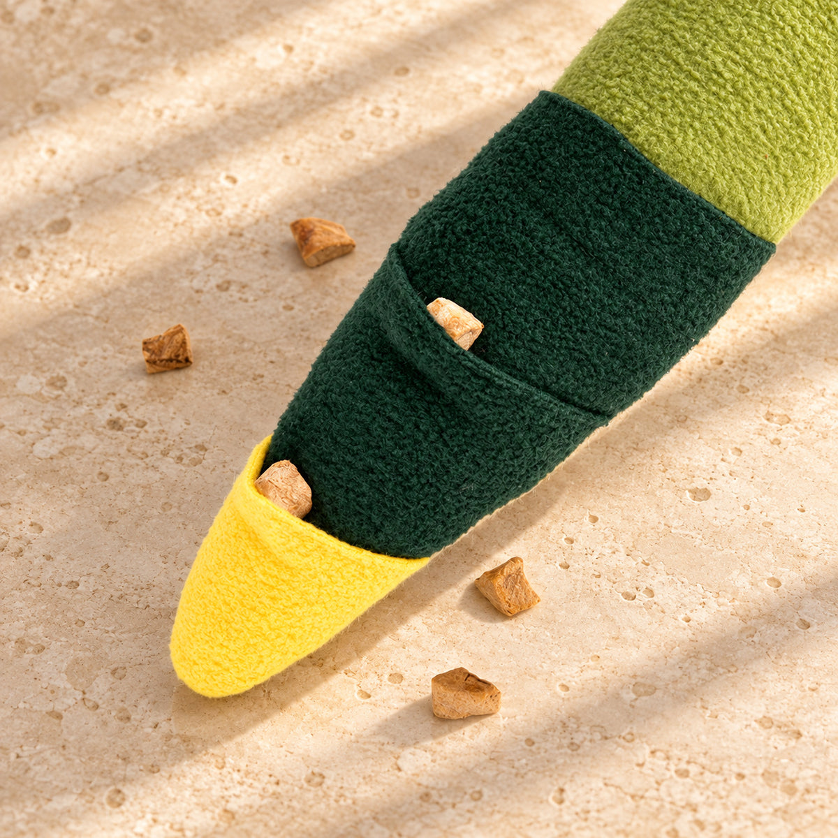 Treat pockets in the dark green and yellow tail of the snake snuffle toy