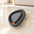 Load image into Gallery viewer, Grey triangle cat track toy with orange ball on beige marble
