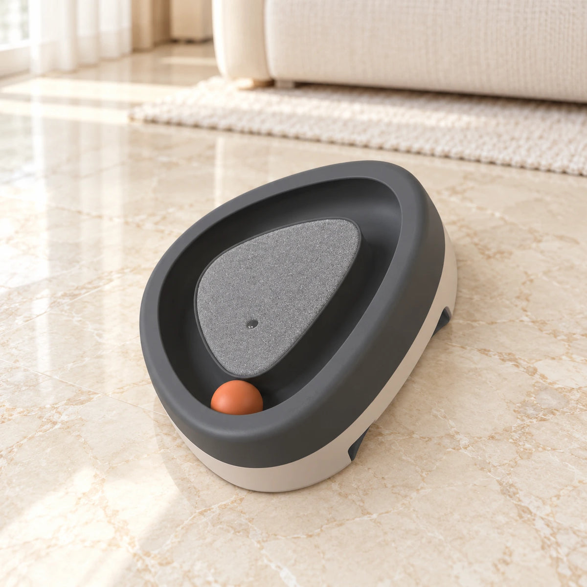 Grey triangle cat track toy with orange ball on beige marble