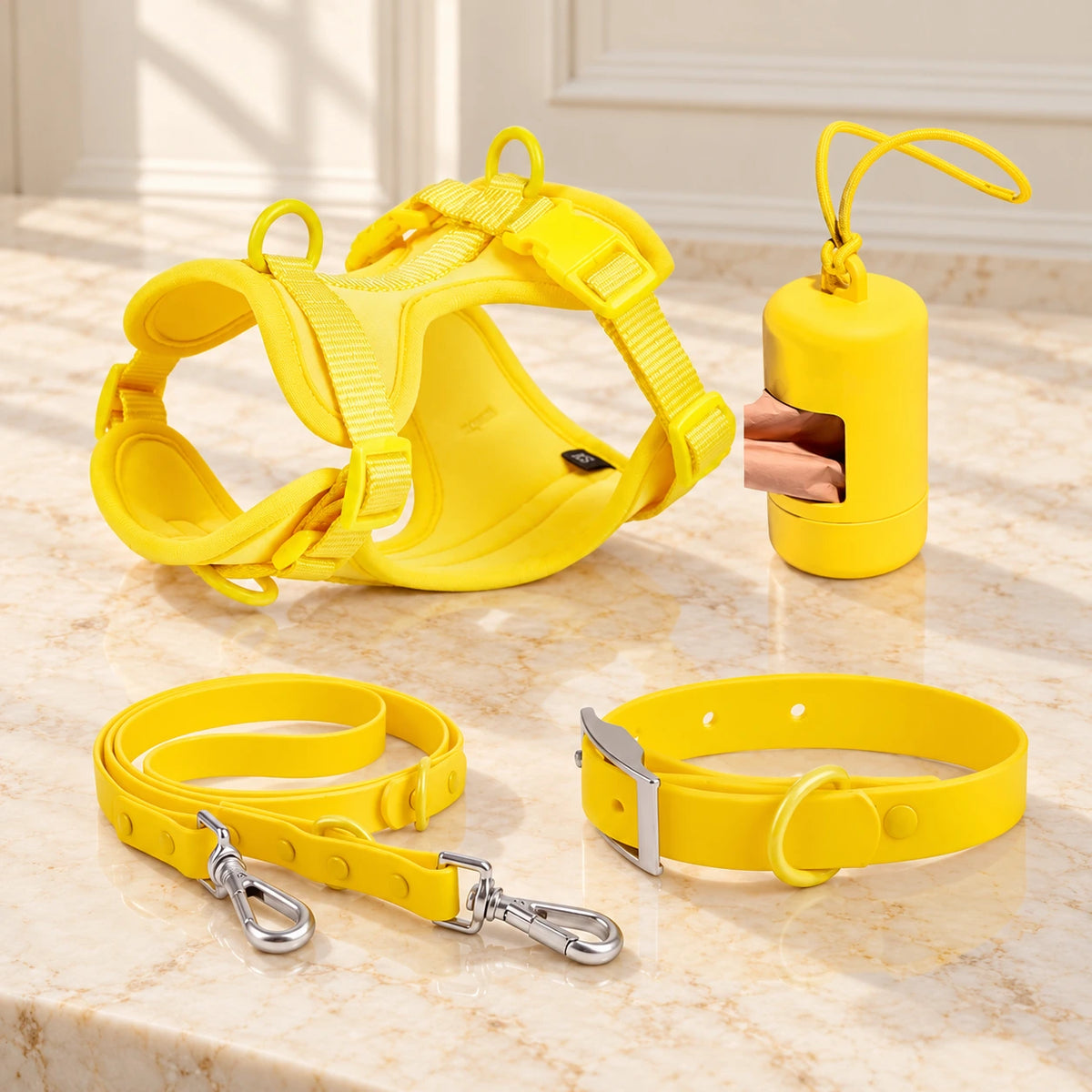 Yellow dog harness, collar, lead and bag holder arranged on beige marble
